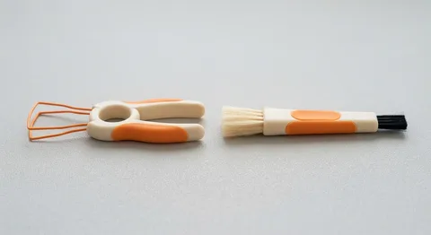 Keycap puller and cleaning brush in cream and orange